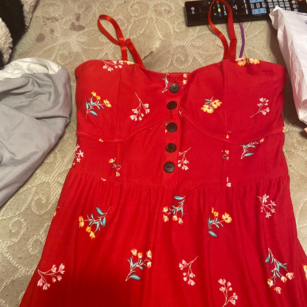 I’m selling a no boundaries red flower dress it’s is a Large color of it is red